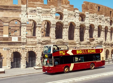 Rome hop-on hop-off bus tour open-top double-decker passing the Colosseum